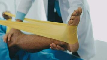 A physiotherapist doing treatment with patient in bright office video