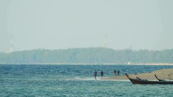 View of the sea coast and tourists walking in the distance. Travel and tourism concept video