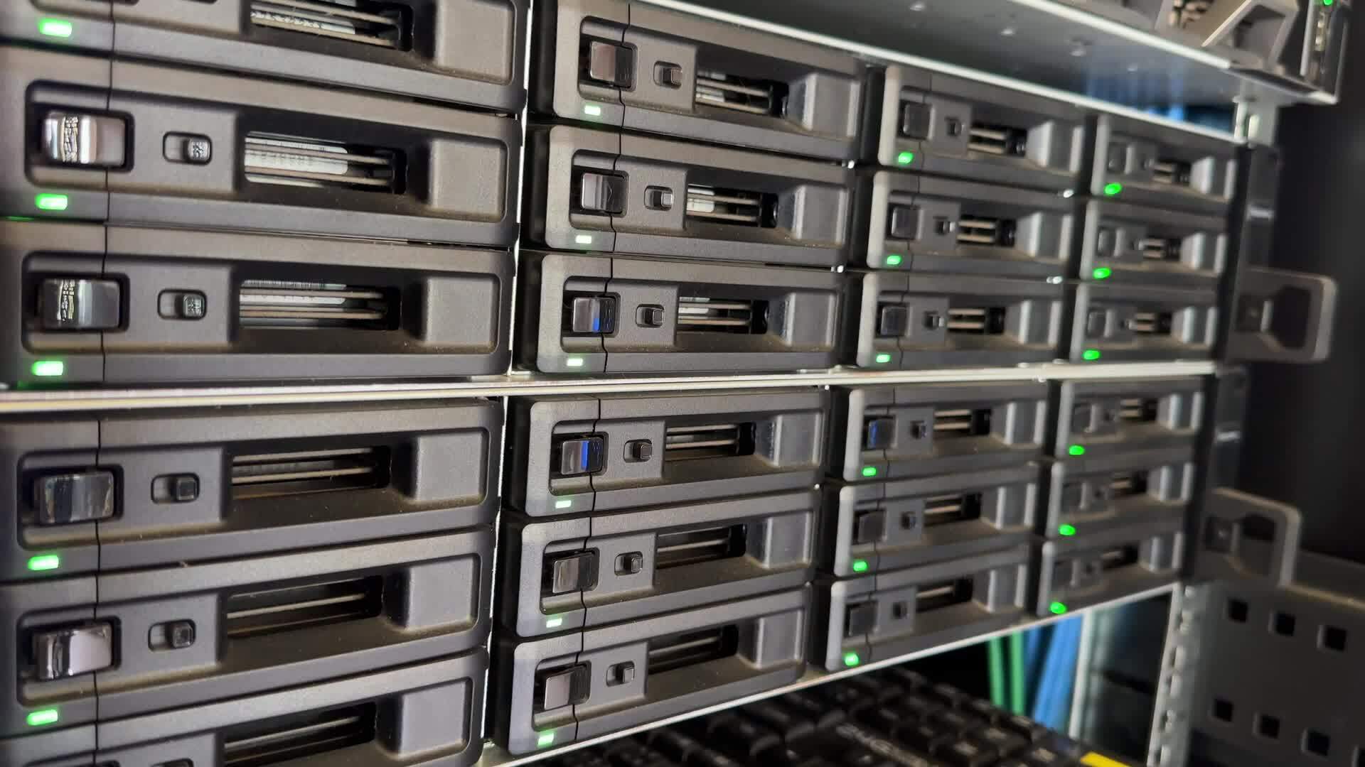 Engineer working in a data center. Hard drive insert. many hard drives