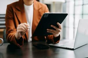 Bussinessman analyzing sales data and economic growth and pointing at business report document with graph chart financial chart marketing, banking and payments at modern office photo