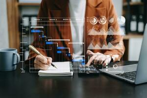 Businessman hand Project manager working and update tasks and Gantt chart scheduling virtual diagram.with smart phone, tablet and laptop in modern office. photo