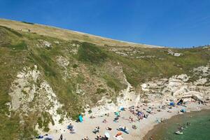 High Angle View of People are Approaching to Durdle Door Beach Which is Most Famous Tourist Attraction Place Through Walking Distance over Landscape and Hills. Captured on September 9th, 2023 photo