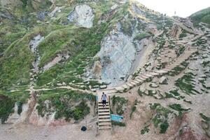 High Angle View of People are Approaching to Durdle Door Beach Which is Most Famous Tourist Attraction Place Through Walking Distance over Landscape and Hills. Captured on September 9th, 2023 photo