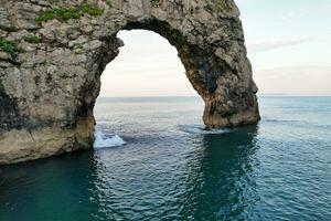 Most Beautiful View of British Landscape and Sea View of Durdle Door Beach of England Great Britain, UK. Image Was captured with Drone's camera on September 9th, 2023 photo