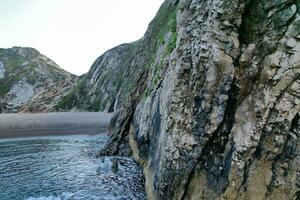 Most Beautiful View of British Landscape and Sea View of Durdle Door Beach of England Great Britain, UK. Image Was captured with Drone's camera on September 9th, 2023 photo