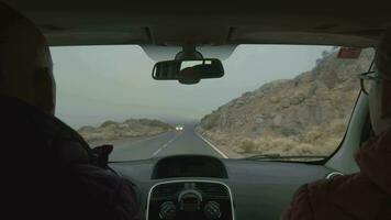 A mountain road view from the windshield of a moving car video