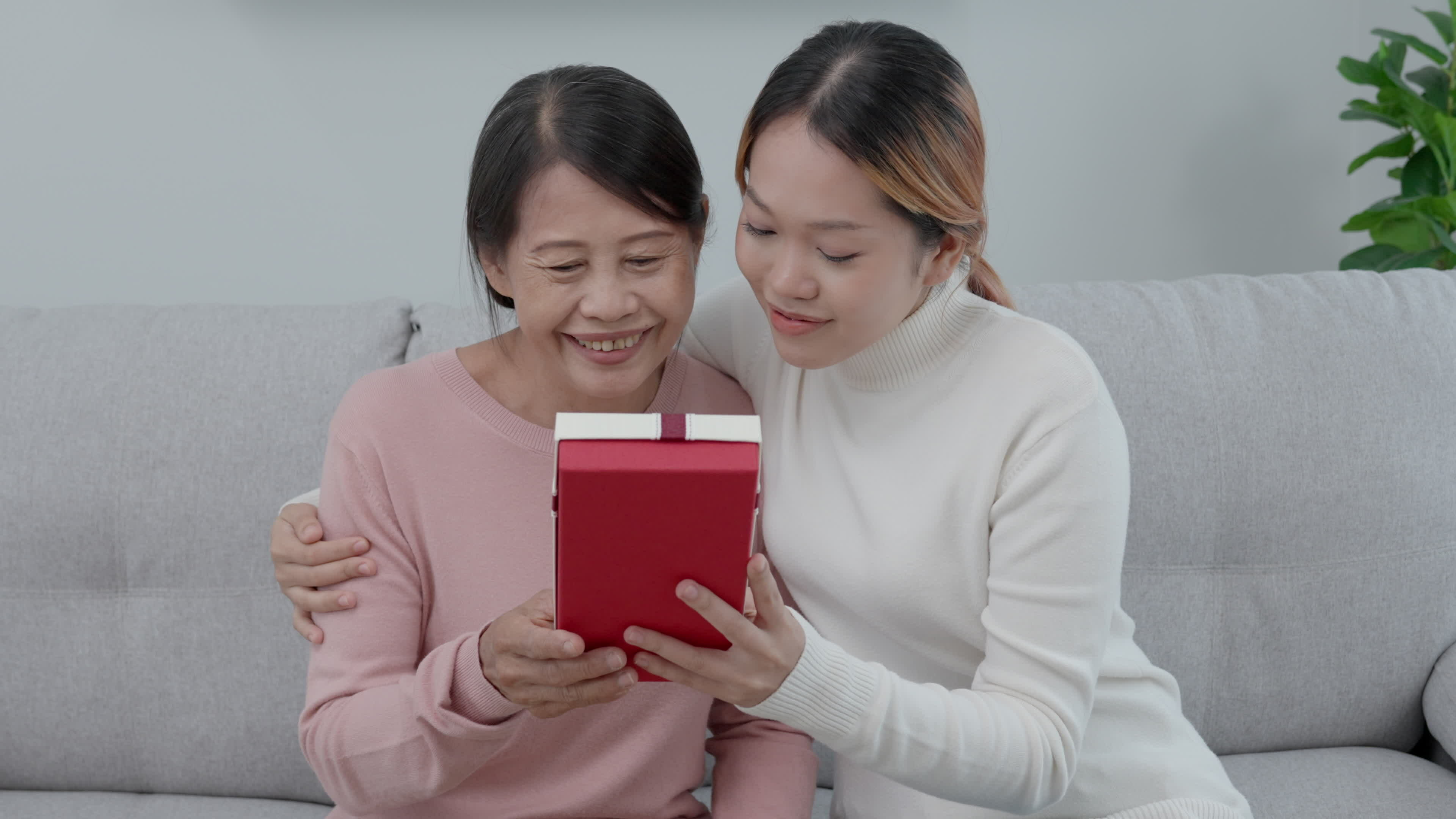 Mother day, cute asian teen girl give gift box to mature middle age mum.  Love, kiss, care, happy smile enjoy family time. celebrating special  occasion, happy birthday, happy new years, merry Christmas