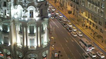 Edificio Metropolis and road traffic in night Madrid, Spain video