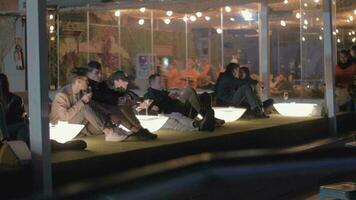 People relaxing in rooftop restaurant Azotea del Circulo at night. Madrid, Spain video