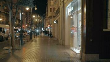 People walking on Carrer de Colon in night Valencia, Spain video