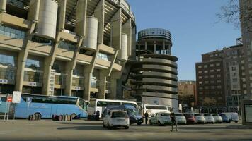 Outside view of Santiago Bernabeu Stadium with transport parked nearby, Madrid video