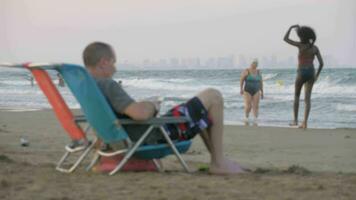 People on city beach with wavy sea in Valencia, Spain video