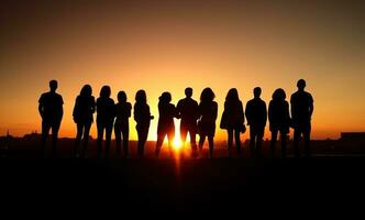 Group of people silhouette in the sunset photo