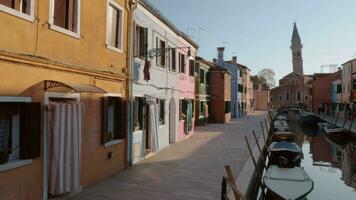 A beautiful view of italian Burano with colorful facades and boats on a narrow canal video