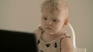 Little girl watching cartoons on tablet computer at home video