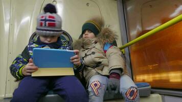 Timelapse of two boys with tablet computer in trolleybus video