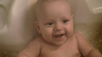 Cute cheerful baby bathing video