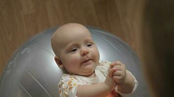 Baby girl on gymnastic ball video