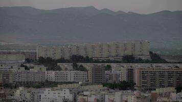 Alicante buildings against misty evening mountains video