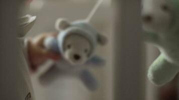 A closeup of a toy bear being played by a baby video