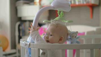 Cute baby girl in a round crib close up 6 video