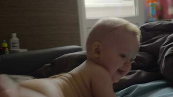 Naked baby girl playing video