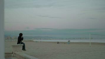 Man talking on his cellphone beside the sea video