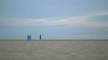 Jogger running beside the sea on a cold day video