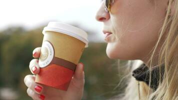 Woman drinking coffee on a cold day outside video