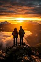 Two persons on the top of the mountain at sunset photo