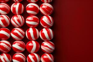 A close-up shot of candy canes arranged on peppermint striped backgrounds with empty space for text photo