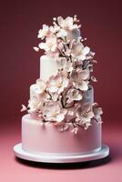 Three-tier elegant wedding cake with delicate edible decorations isolated on a pink gradient background photo