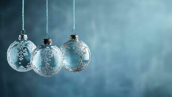 Antique glass ball ornaments kissed with frost hanging isolated on a dusky blue to icy white gradient background photo