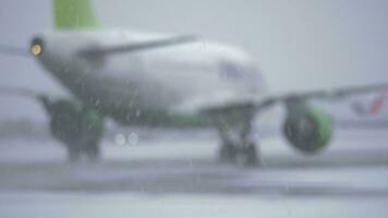 Blur of airplane driving on the landing strip, view in snowfall video