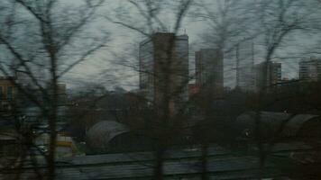 Looking at evening city from the window of moving train, Russia video