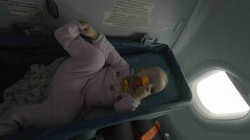 Baby girl in airplane bassinet video