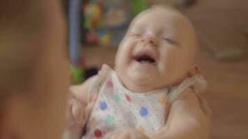 Mother playing with her newborn giggling daughter video