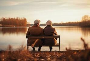 a picture of an older couple sitting by the water. photo