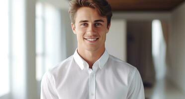 a man is smiling while holding a white shirt. photo