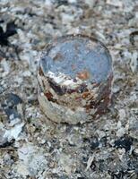 old rusty iron can on the ground photo