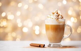cup of latte with cinnamon and whipped cream, blurred, sparkling and fabulous white background with beautiful bokeh, light orange gold, festive atmosphere, cinnamon powder on the table. photo