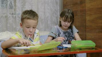 Children drawing pictures and eating candies video