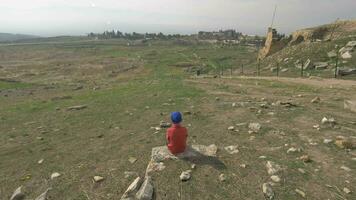 A steadicam shot of a boy looking at the ruins of ancient Hierapolis video