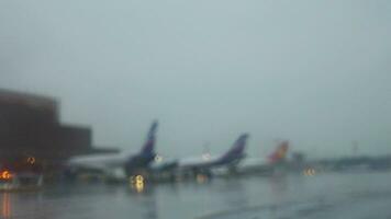 Blurred airport view with planes and vehicles traffic video