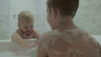 Brother and baby sister playing in the bathroom video