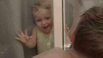 Brother and junior sister laughing when having fun at home video