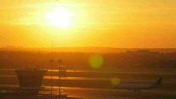 Wide shot of air traffic control tower at sunset video