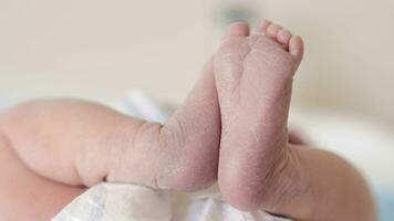 Newborn baby girl with her feet in the air video