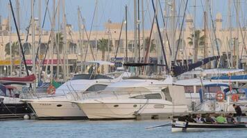 Quay view with moored yachts and sailing rowing boat video