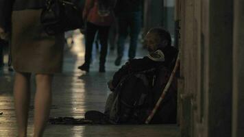 Man beggar sitting in busy street video